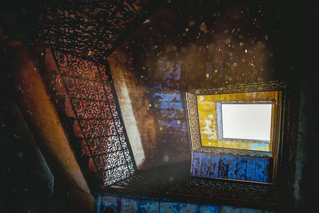 Sunlight and dust motes streaming through a window onto a staircase