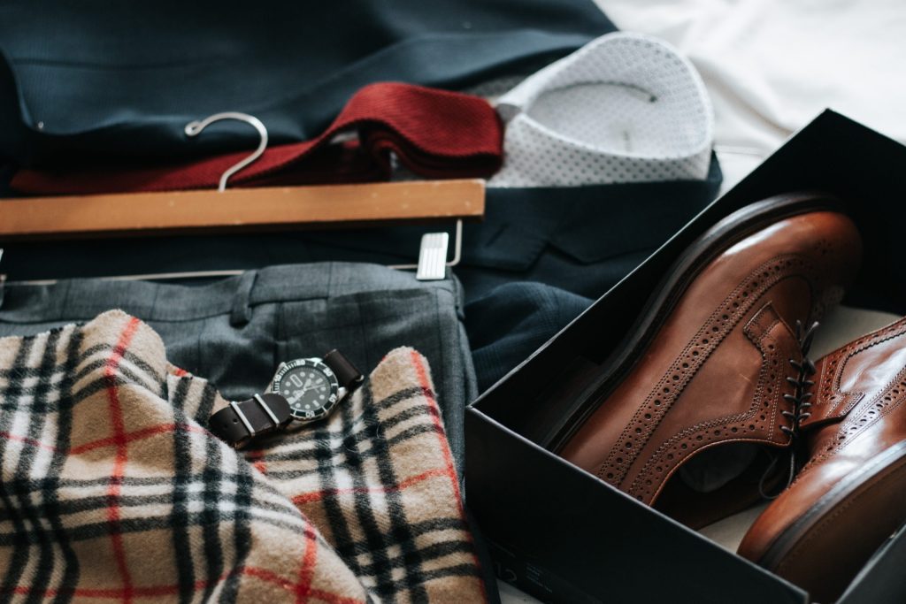 A neatly laid-out men's outfit with jacket, shirt, tie and shoes