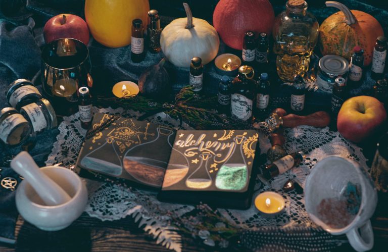 Homemade cleaning ingredients, bottles and a mortar and pestle on a dark table