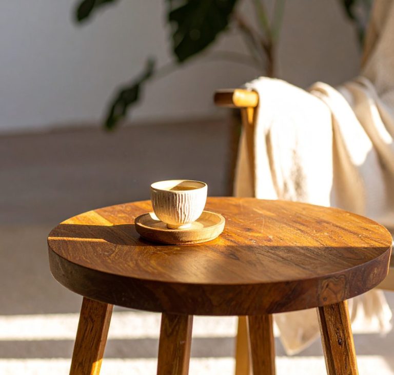 A cup of coffee on a small round wooden stool