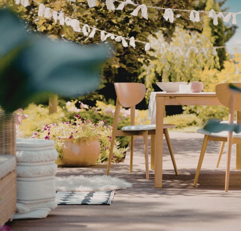 Outdoor patio dining set on a sunny garden terrace